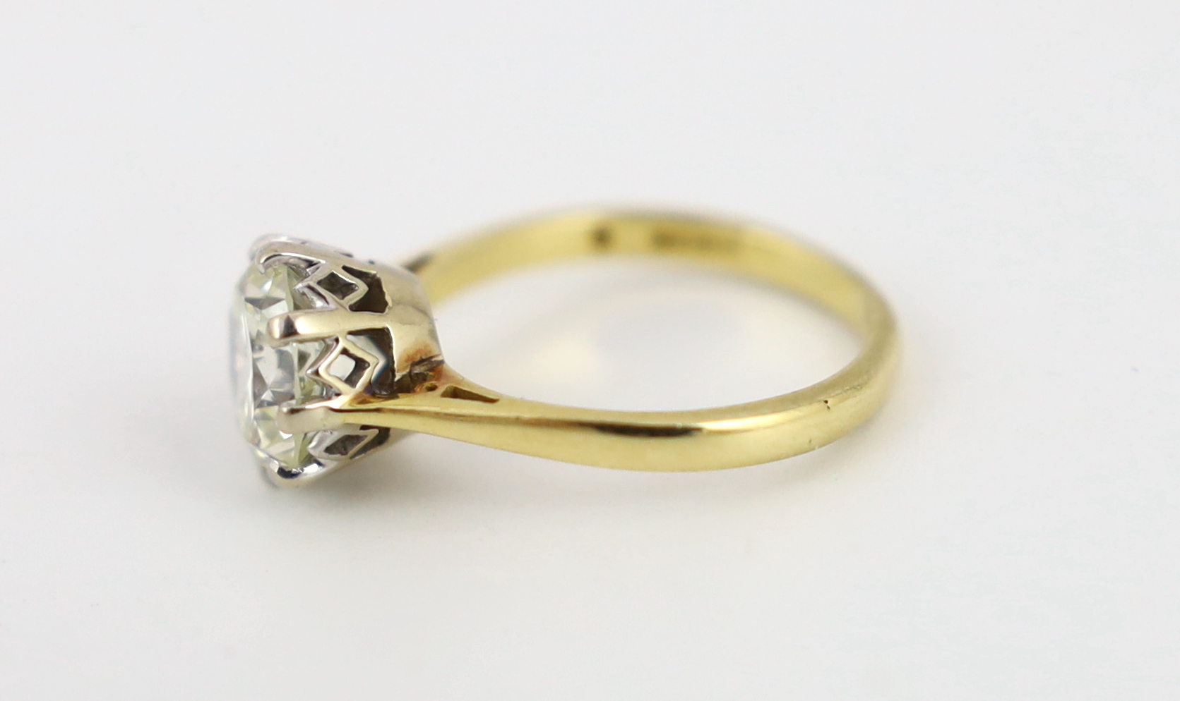 A modern 18ct gold and solitaire diamond set ring